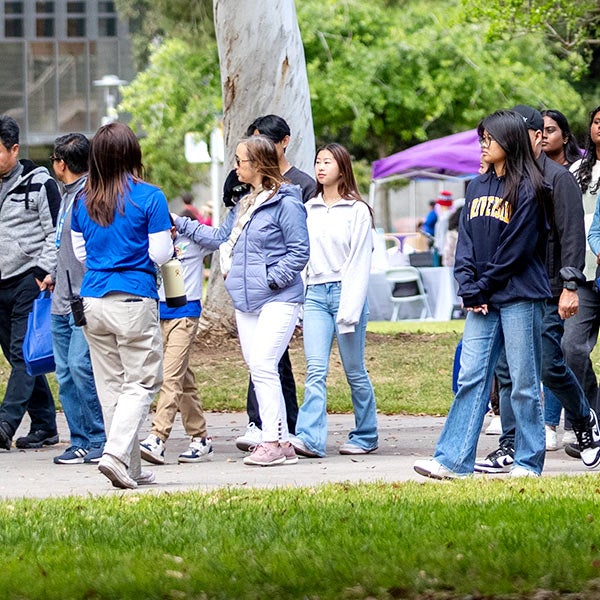 A Campus Tours Guide leads visitors on Highlander Day.