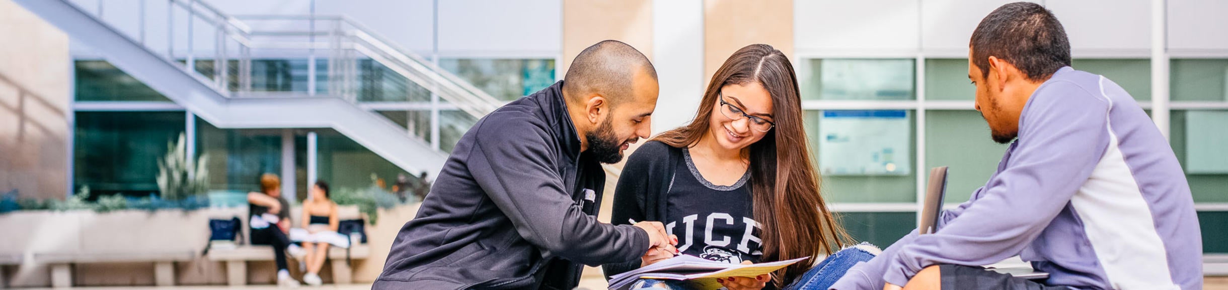 Three students study outdoor on the UC Riverside campus