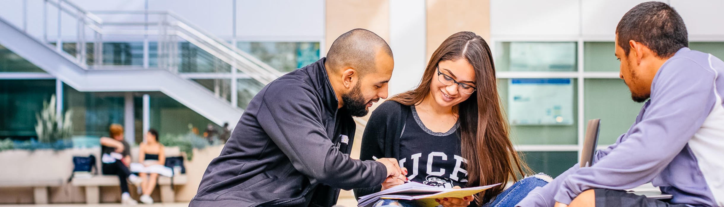 Three students study outdoor on the UC Riverside campus